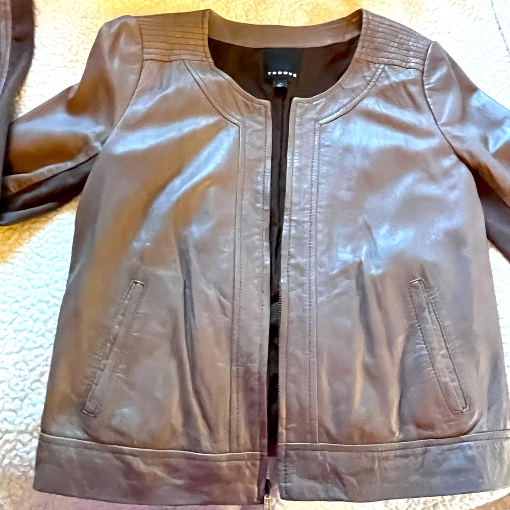 Pewter , leather jacket   Round collar, zip front material under arms, pleating